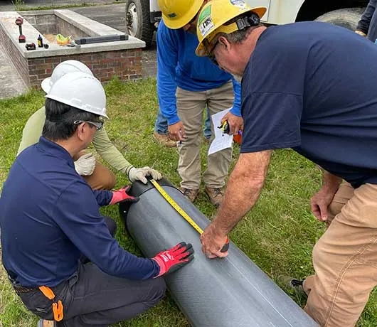 Men measuring a utility pole